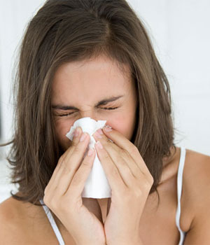 woman hay fever blowing nose